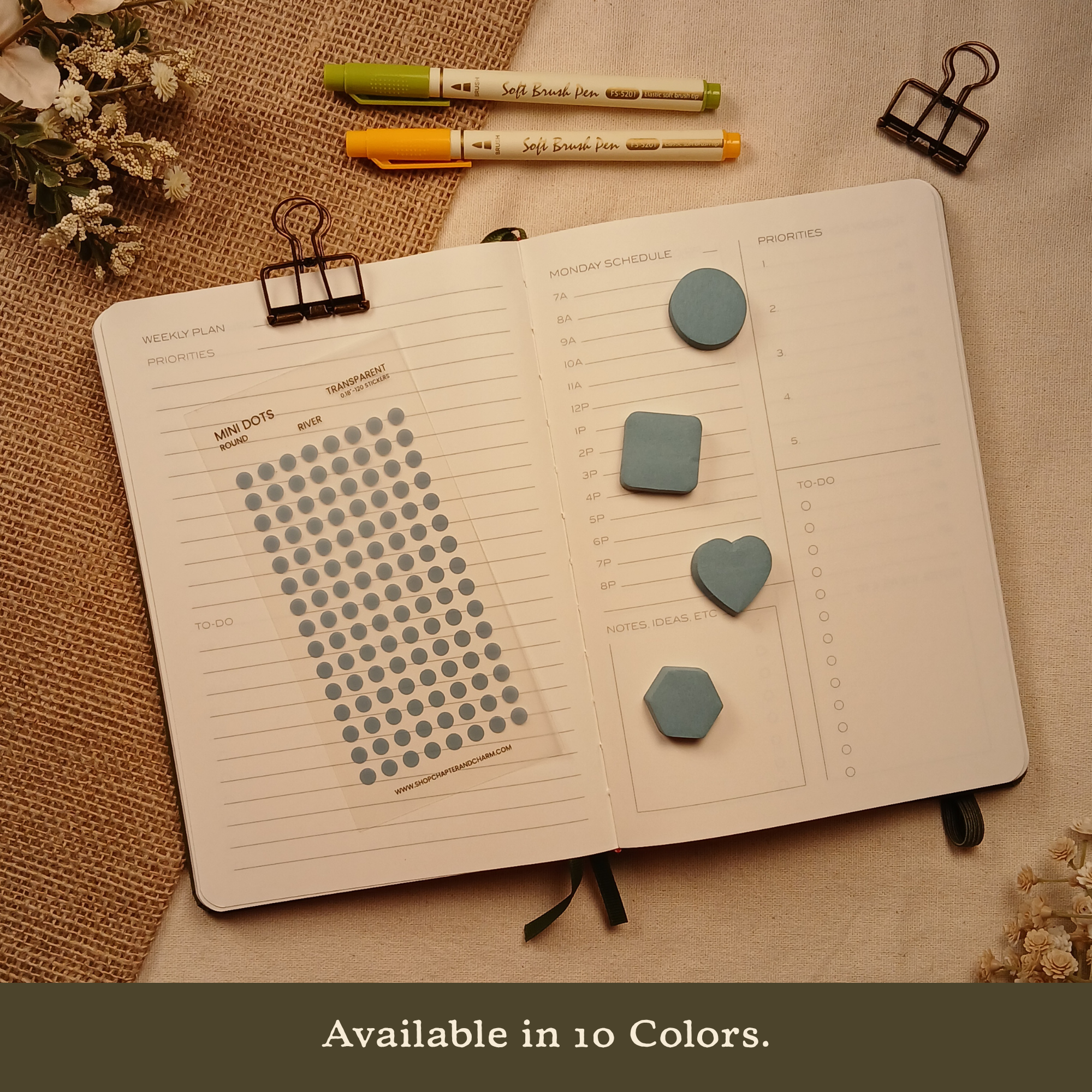 River blue transparent matte round planner dot stickers displayed on an open planner with matching round, square, heart, and hexagon sticky notes. The image includes the text, 