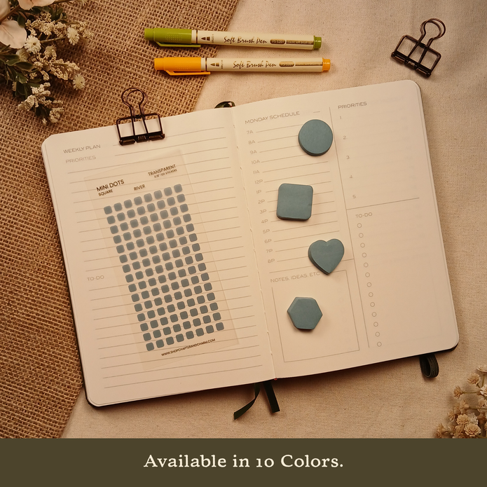 River blue transparent matte square planner stickers displayed on an open planner with coordinating round, square, heart, and hexagon sticky notes. The image includes the text, 
