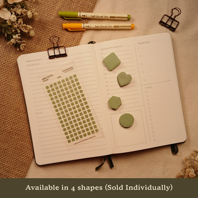 Fern green transparent matte square planner stickers displayed with coordinating heart, circle, square, and hexagon sticky notes on an open planner. The image includes the text, 