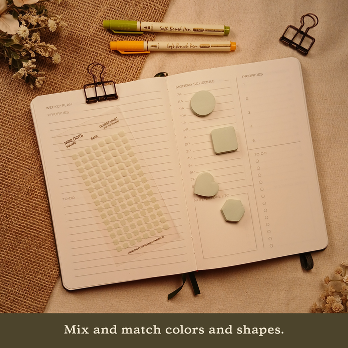 Sage green transparent matte square planner stickers displayed with coordinating sticky notes on an open planner. The image includes the text, 