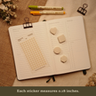 Tan transparent matte square planner stickers displayed with matching sticky note shapes on an open planner. The image includes the text, 