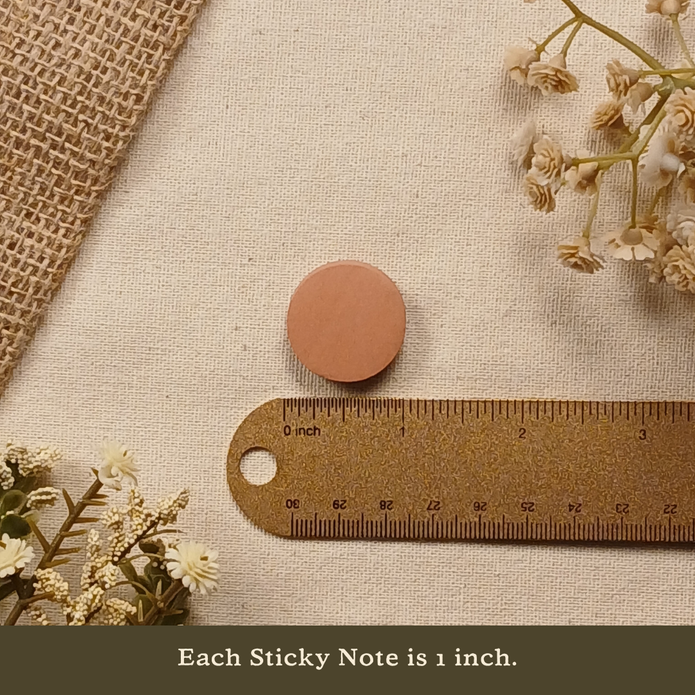 One-inch round sticky note displayed next to a ruler on a neutral linen background with the text 