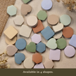 Assortment of pastel sticky notes in heart, circle, hexagon, and rounded square shapes displayed on a neutral linen background with the text 