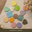 Transparent sticky notes in heart, circle, hexagon, and rounded square shapes displayed in multiple colors on a neutral linen background with the text 