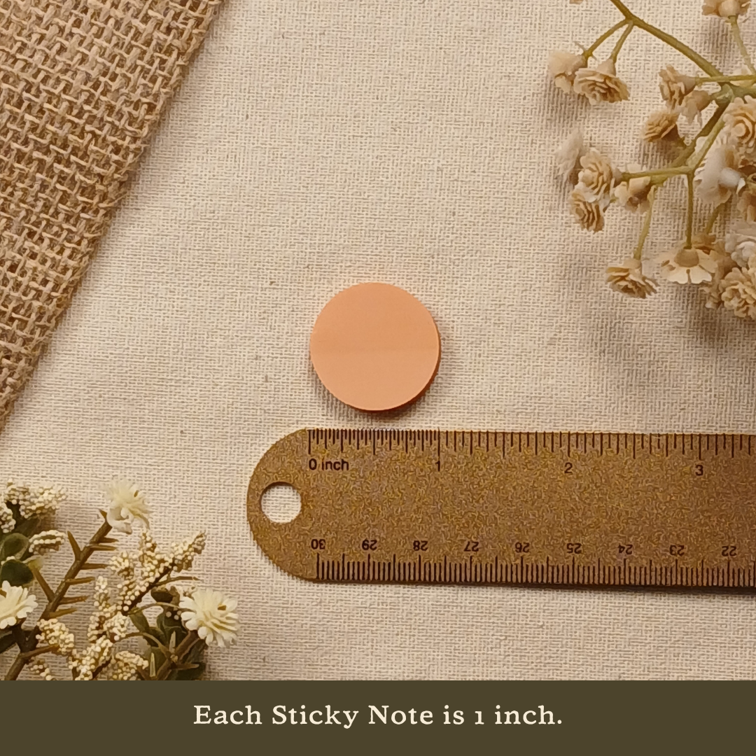 One-inch transparent round sticky note displayed next to a ruler on a neutral linen background with the text 